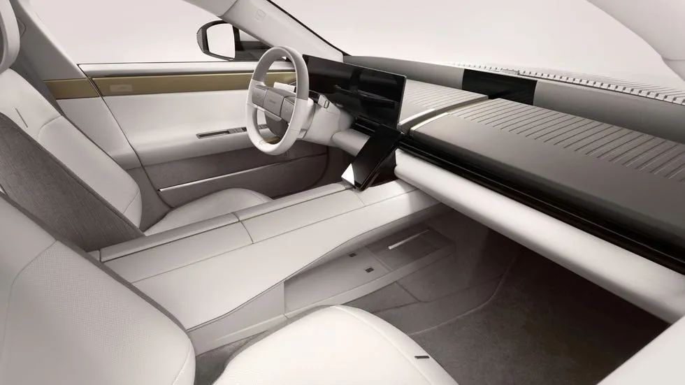 Interior view of a modern car featuring a sleek design with white and gray upholstery.